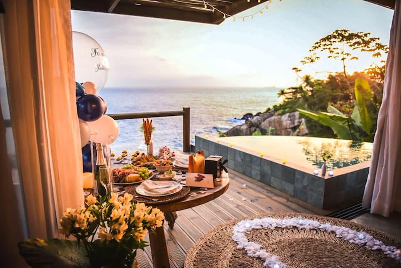 Deck with an infinity pool over the sea at sunset